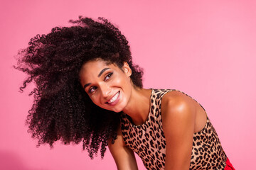 Photo of lovely young lady fluttering hair volume look empty space dressed stylish leopard print garment isolated on pink color background