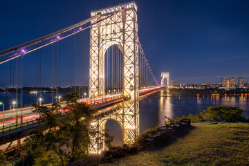 The illuminated George Washington Bridge crossing the Hudson River in evening. New York City