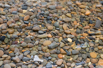 Decorative garden stones in the pond, Various pebbles and peach stones for texture background.