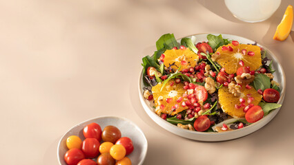 Vegan salad with citrus fruits, lettuce leaves and pomegranate. Christmas salad. 