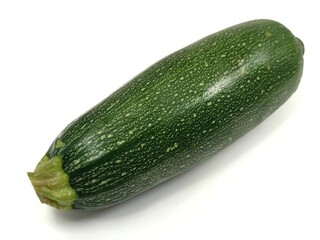 Closeup of a fresh zucchini, also known as courgette or baby marrow (Cucurbita pepo), isolated on a white background. 
