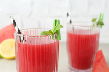 Delicious watermelon drink in glasses on table, closeup