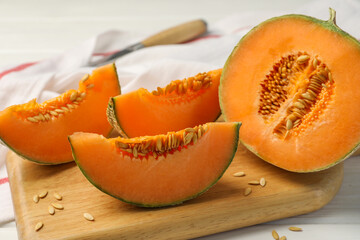 Cut ripe Cantaloupe melon on white table