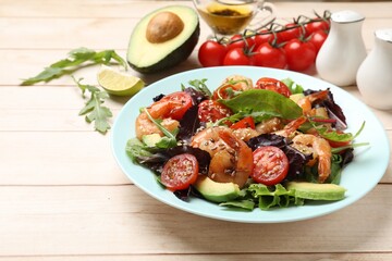 Delicious shrimp salad and ingredients on white wooden table, closeup