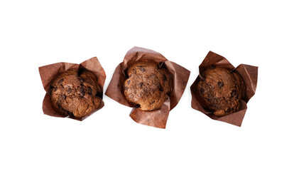 Delicious sweet muffins with chocolate chips isolated on white, top view