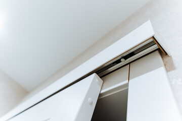 The image presents a detailed closeup of a sliding door situated within a room, showcasing its...