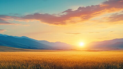 A stunning sunset over a golden wheat field with distant mountains.