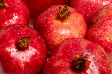 closeup of ripe organic pomegranates with drops