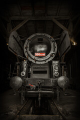 a historic steam locomotive peeking out from the depot