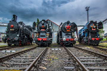 Obraz premium historic steam locomotives resting in the depot