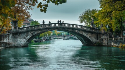 Fototapeta premium Bridge spanning a river, with pedestrians enjoying the view