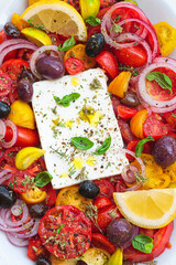Greek salad with feta cheese and herbs. Greek bowl. Mediterranean cuisine and Greece. Healthy eating and recipes, close up