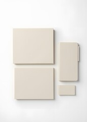 Notebooks of varying sizes sit on a pristine white surface.