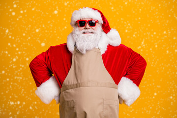 Photo of santa claus role grandpa grey beard wait children parents family take order waiter own business cafe wear red costume coat gloves sun specs cap apron isolated yellow color background