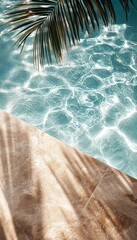 Obraz premium Tranquil sunlight reflecting on clear pool water beside a serene stone patio with palm leaves