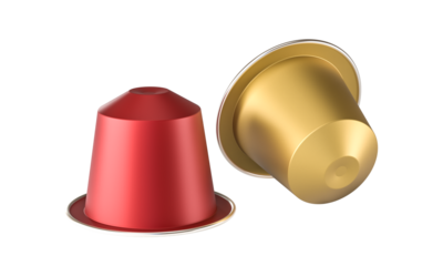 Red and gold coffee capsules lying on white background