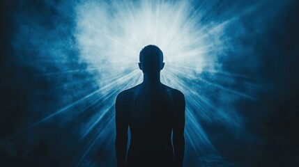 A silhouette of a person standing in front of a bright light, symbolizing hope, enlightenment, or a new beginning.