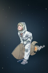 A young boy in a spacesuit is standing on a cardboard rocket