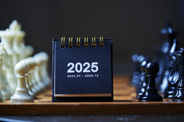 chess pieces and desk calendar 2025
