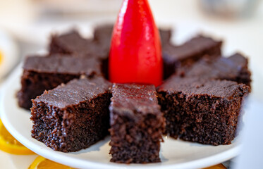 Chocolate brownie pieces lie on a plate.