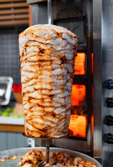Juicy meat is fried on a shawarma spit.