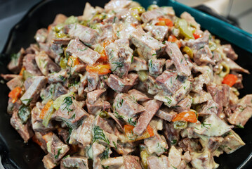 Beef tongue salad with vegetables and sauce.