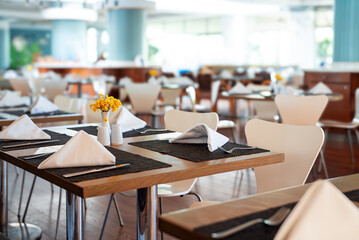 Setout table with tableware in restaurant.