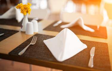 Setout table with tableware in modern restaurant.