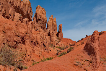 Fototapeta premium Northern Kyrgyzstan. Picturesque views of the famous Skazka Canyon, the clay mountain peaks of which have bright colors from yellow to red-brown.
