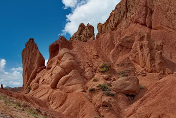 Fototapeta premium Northern Kyrgyzstan. Picturesque views of the famous Skazka Canyon, the clay mountain peaks of which have bright colors from yellow to red-brown.