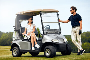 A lovely couple basking in the joys of a delightful day dedicated to golfing on the course