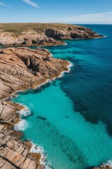 Obraz premium Aerial View of Turquoise Sea and Rocky Coast.