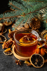 Tea with spices and dry fruits on a kitchen table.
