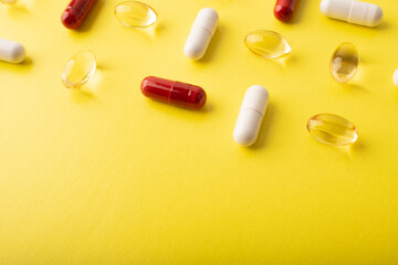 Pills. Supplements omega 3, vtamin C. White pills, red capsules on yellow background. An allergy pill, antibiotics. Medicine, healthcare concept. Virus(viral) and flu diseases. High quality photo