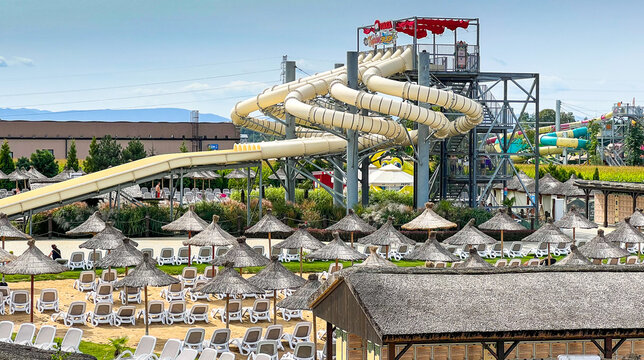 huge water slides and multiple exotic umbrellas in Energylandia water park in Zator, Poland. View on the biggest water park in Europe.