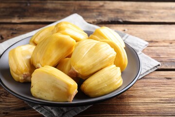 Delicious exotic jackfruit bulbs on wooden table