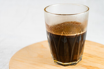 Glass of Black Coffee with Frothy Cream