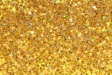 Sparkling gold star confetti background for celebrations and festive decor.