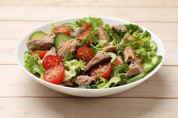 Delicious fresh tuna salad on white wooden table, closeup