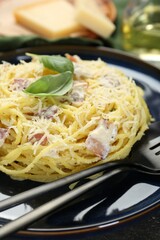 Plate with delicious pasta Carbonara on table, closeup