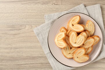 Delicious sweet palmier cookies on wooden table, top view