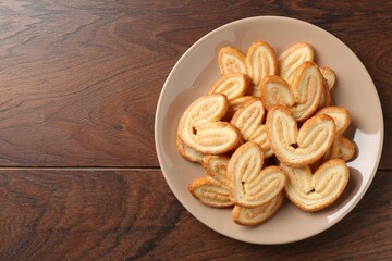 Delicious sweet palmier cookies on wooden table, top view