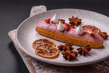 Sweet eclair or profiterole with strawberry custard