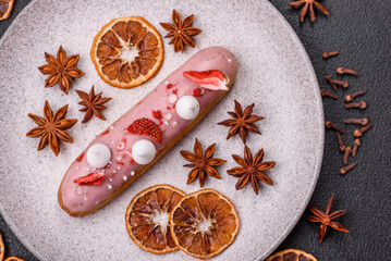 Sweet eclair or profiterole with strawberry custard