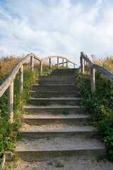 A staircase between the sand dunes with beach grass