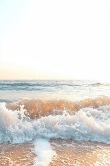 Fototapeta premium Waves crashing on the shore, bright sky in the background