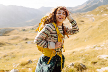 Young woman backpacker on mountains cliff hiking enjoy landscape. Adventure active. Mountain climbing.