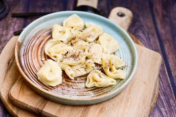 Home made Italian   Tortelloni fresh pasta   with  parmesan cheese filled with mozzarella cheese, decorated with fresh basil