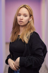 Closeup of a young woman's visage with piercing hanging from her nose.