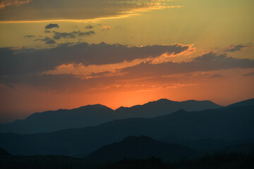 Beautiful sunset over the mountains in the summer.
